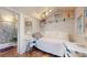 Cozy shed with white shiplap walls, a small bed, and a door to a bathroom at 75 Adalia Ave, Tampa, FL 33606