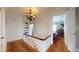 Elegant hallway with hardwood floors, chandelier lighting, and built-in shelving at 75 Adalia Ave, Tampa, FL 33606