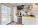 Cozy kitchenette with mini fridge, microwave, and shelving, offering compact convenience at 75 Adalia Ave, Tampa, FL 33606