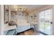 Cozy room with white wood paneling, desk, bed and natural light. Ideal small office at 75 Adalia Ave, Tampa, FL 33606