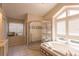 Bathroom featuring a large window, a step-in shower, and a bathtub at 7838 Trail Run Loop, New Port Richey, FL 34653