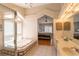 Bathroom featuring double sinks, a mirror with lighting, a step-in shower and a bathtub at 7838 Trail Run Loop, New Port Richey, FL 34653
