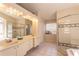 This bathroom features double sinks, a large mirror, and a glass shower enclosure at 7838 Trail Run Loop, New Port Richey, FL 34653