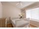 Bright bedroom with neutral walls, wood floors, and a large window, creating a serene atmosphere at 7838 Trail Run Loop, New Port Richey, FL 34653