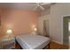 Cozy bedroom with warm-toned walls, hardwood floors, and a ceiling fan for added comfort at 7838 Trail Run Loop, New Port Richey, FL 34653
