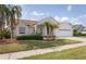 Well-maintained home featuring lush landscaping, a two-car garage, and an inviting facade at 7838 Trail Run Loop, New Port Richey, FL 34653