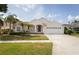 Charming single-story home with well-manicured lawn, mature landscaping, and a two-car garage at 7838 Trail Run Loop, New Port Richey, FL 34653