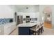 Bright kitchen featuring white cabinetry, stainless appliances, and a beautiful blue tile backsplash at 7838 Trail Run Loop, New Port Richey, FL 34653