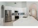 Bright kitchen featuring white cabinetry, stainless appliances, and a beautiful marble-look countertop at 7838 Trail Run Loop, New Port Richey, FL 34653