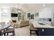 Bright open floor plan with a fireplace and kitchen area with white cabinets and stylish backsplash at 7838 Trail Run Loop, New Port Richey, FL 34653