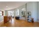 Open living space featuring hardwood floors, a bar area, and archways to other living spaces at 7838 Trail Run Loop, New Port Richey, FL 34653