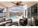 Relax on this screened lanai, complete with a ceiling fan and view of the inviting pool at 7838 Trail Run Loop, New Port Richey, FL 34653