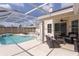 Beautiful screened-in pool with outdoor seating area perfect for relaxation and entertaining at 7838 Trail Run Loop, New Port Richey, FL 34653