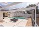 Lovely screened-in pool and deck area with lounge chairs for ultimate relaxation at 7838 Trail Run Loop, New Port Richey, FL 34653