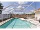 Inviting screened-in pool featuring a sun deck area for lounging and relaxation at 7838 Trail Run Loop, New Port Richey, FL 34653