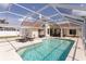 Relaxing screened-in pool with chairs and outdoor seating near the home at 7838 Trail Run Loop, New Port Richey, FL 34653