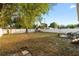 Large fenced backyard featuring a shed for storage, a patio area, and mature trees, perfect for relaxation and recreation at 8001 N Ola Ave, Tampa, FL 33604