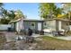 View of the home's backyard featuring a patio space with furnishings, barbeque, and fenced perimeter at 8001 N Ola Ave, Tampa, FL 33604