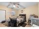 Bedroom featuring a ceiling fan, window AC unit and furnished with small table and personal refrigerator at 8001 N Ola Ave, Tampa, FL 33604