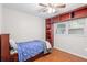 Inviting bedroom with hardwood floors, built-in shelves, ceiling fan and natural light, ideal for relaxation at 8001 N Ola Ave, Tampa, FL 33604