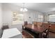 Inviting dining room featuring wood table with bench and chairs, neutral walls, and a view to living area at 8001 N Ola Ave, Tampa, FL 33604