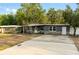 Charming single-story home with stone accents, neutral paint, well-maintained landscaping, and a welcoming front entrance at 8001 N Ola Ave, Tampa, FL 33604