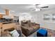 Bright and airy living room with wood floors, modern lighting, and seamless access to the kitchen and dining space at 8001 N Ola Ave, Tampa, FL 33604