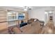 Inviting living room with wood floors, built-in shelves, and a large window that offer a comfortable, airy ambiance at 8001 N Ola Ave, Tampa, FL 33604