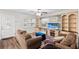 Cozy living room featuring built-in shelving, a decorative fireplace, and a large window for natural light at 8001 N Ola Ave, Tampa, FL 33604