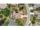 Aerial view showcasing the home's layout, screened pool, landscaping, and neighborhood surroundings at 8308 Mobile Cir, Weeki Wachee, FL 34613