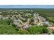 An aerial photograph showing homes in a neighborhood with mature trees and landscaping at 8308 Mobile Cir, Weeki Wachee, FL 34613