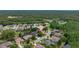 Wide aerial view of a residential community surrounded by green spaces and lush landscaping at 8308 Mobile Cir, Weeki Wachee, FL 34613