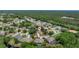 Aerial view of the community with mature trees surrounding well-maintained homes at 8308 Mobile Cir, Weeki Wachee, FL 34613