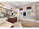 Expansive bathroom with tiled flooring, soaker tub, and double sink vanity at 8308 Mobile Cir, Weeki Wachee, FL 34613