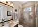 Neutral toned bathroom featuring a glass enclosed shower, attractive mirror, and single sink vanity at 8308 Mobile Cir, Weeki Wachee, FL 34613