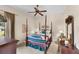 Bedroom boasts a four poster bed, ceiling fan, and carpet flooring at 8308 Mobile Cir, Weeki Wachee, FL 34613