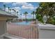 Resort-style community pool surrounded by palm trees and lounge chairs, perfect for relaxation and recreation at 8308 Mobile Cir, Weeki Wachee, FL 34613