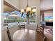 Bright dining area featuring a chandelier and a view of the screened-in pool and backyard at 8308 Mobile Cir, Weeki Wachee, FL 34613