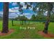 Fenced dog park with trees and a bench providing a secure and pleasant area for pets and their owners at 8308 Mobile Cir, Weeki Wachee, FL 34613