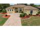 Charming single-story home featuring a brick driveway, well-maintained lawn, and inviting entrance at 8308 Mobile Cir, Weeki Wachee, FL 34613