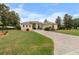 Beautiful home with a brick driveway, lush landscaping, and well-manicured lawn at 8308 Mobile Cir, Weeki Wachee, FL 34613