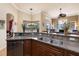 Modern kitchen with stainless steel sink, dark wood cabinets, and open view to the living area at 8308 Mobile Cir, Weeki Wachee, FL 34613