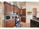 Functional kitchen with dark wood cabinets, stainless steel microwave, and convenient layout at 8308 Mobile Cir, Weeki Wachee, FL 34613