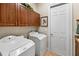 Laundry room featuring a washer, dryer, and storage cabinets at 8308 Mobile Cir, Weeki Wachee, FL 34613