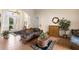 Inviting living room with tile floors, wicker furniture, and bright natural light from the front door at 8308 Mobile Cir, Weeki Wachee, FL 34613