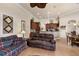 Open-concept living room with tile flooring, wood cabinets, and easy access to the dining area at 8308 Mobile Cir, Weeki Wachee, FL 34613