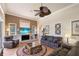 Living room featuring tile flooring, ceiling fan, and multiple windows for natural light at 8308 Mobile Cir, Weeki Wachee, FL 34613