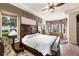 Main bedroom featuring a large bed, sitting area, and multiple windows for lots of natural light at 8308 Mobile Cir, Weeki Wachee, FL 34613