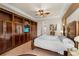 Main bedroom with tile floors, ceiling fan, built-in storage, and large bed at 8308 Mobile Cir, Weeki Wachee, FL 34613