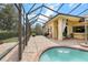 Beautiful screened-in pool area with brick pavers, outdoor kitchen, and plenty of space for entertaining at 8308 Mobile Cir, Weeki Wachee, FL 34613